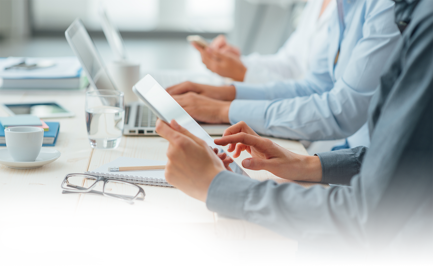 Workers looking at tablets and computers